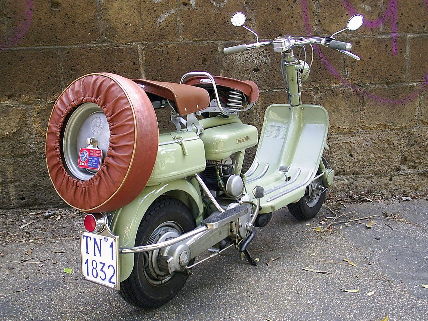The Lambretta 125 F incorporated floorboards and legit suspension. Decked out with a passenger seat, spare wheel, and matching wheel cover, this example shows how important styling was, right from the start.