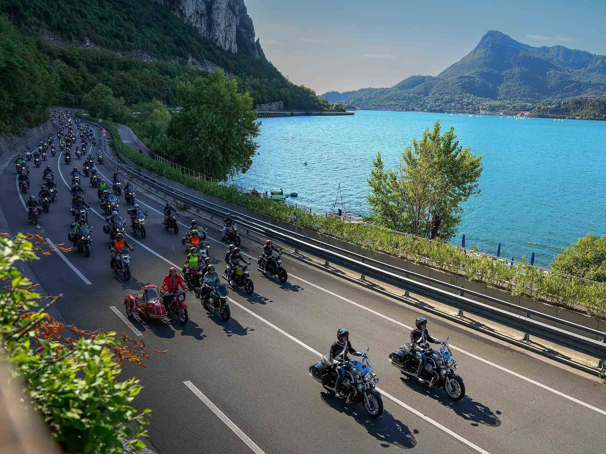 Led by a pair of California 1400 police bikes, a near-endless stream of Moto Guzzis of every age and color make their way on the road circumscribing Lake Como. Squint hard and you’ll make out Ewan McGregor on the V100 next to the red sidecar outfit in the first row.
